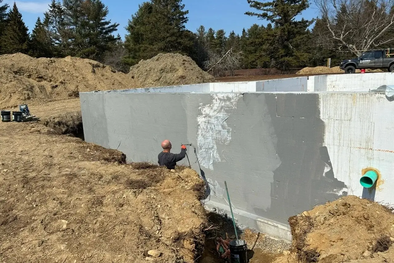 HULK spray-applied waterproofing membrane being installed on a foundation wall by Mariner Construction