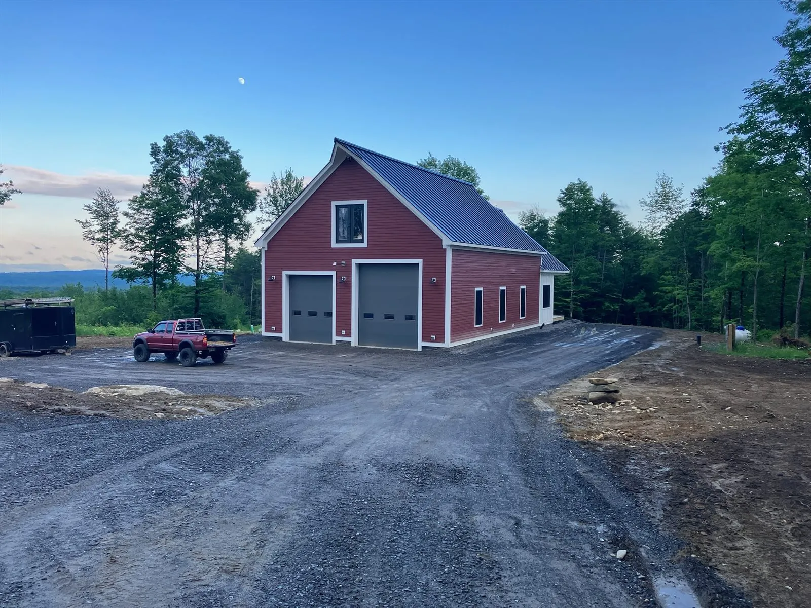 The finished garage at dusk, moon overhead