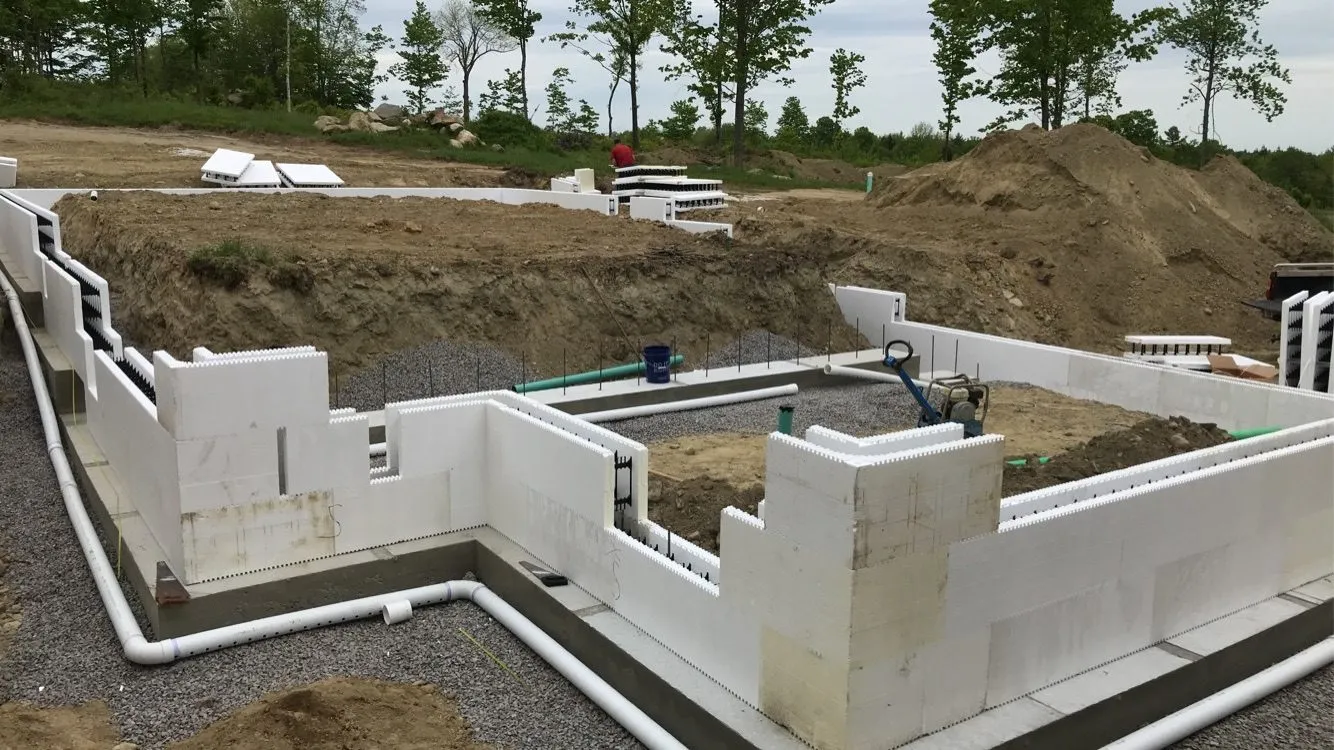 First courses of ICF foundation wall stacked on the footings