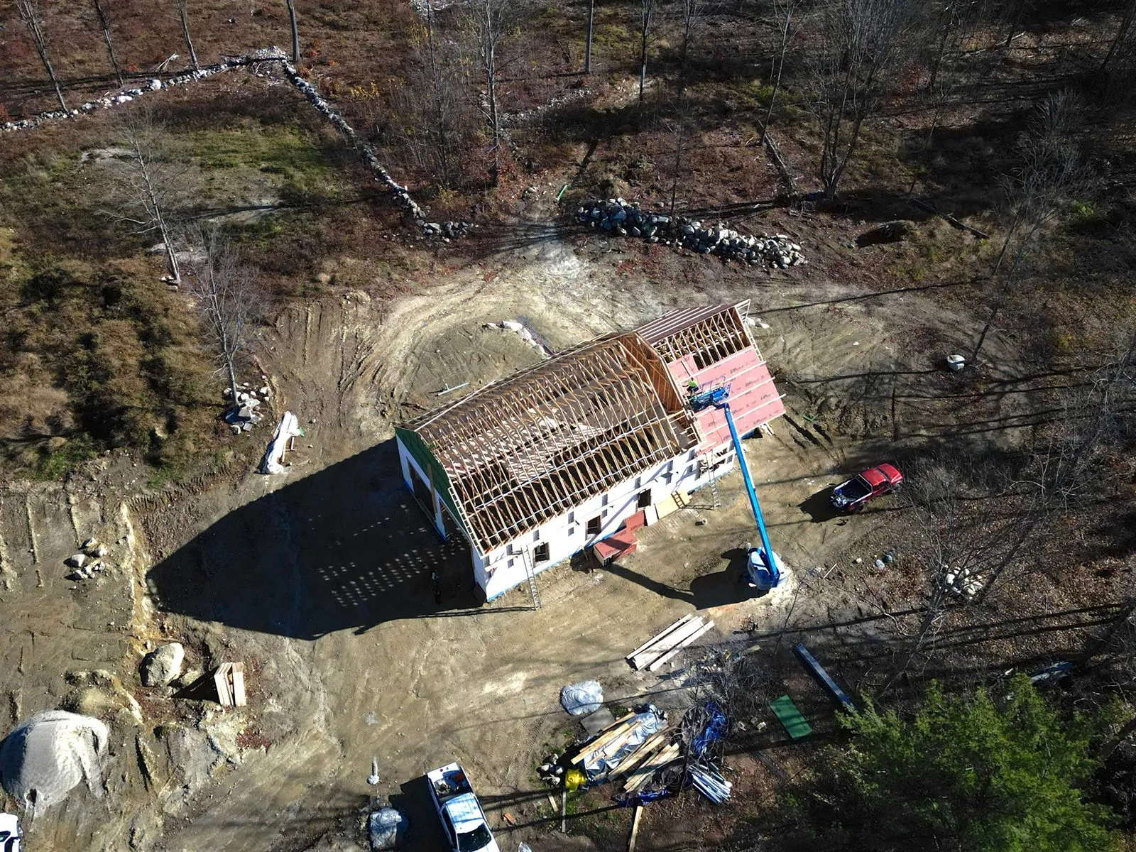 Aerial view of the house with trusses set and the gable sheathed